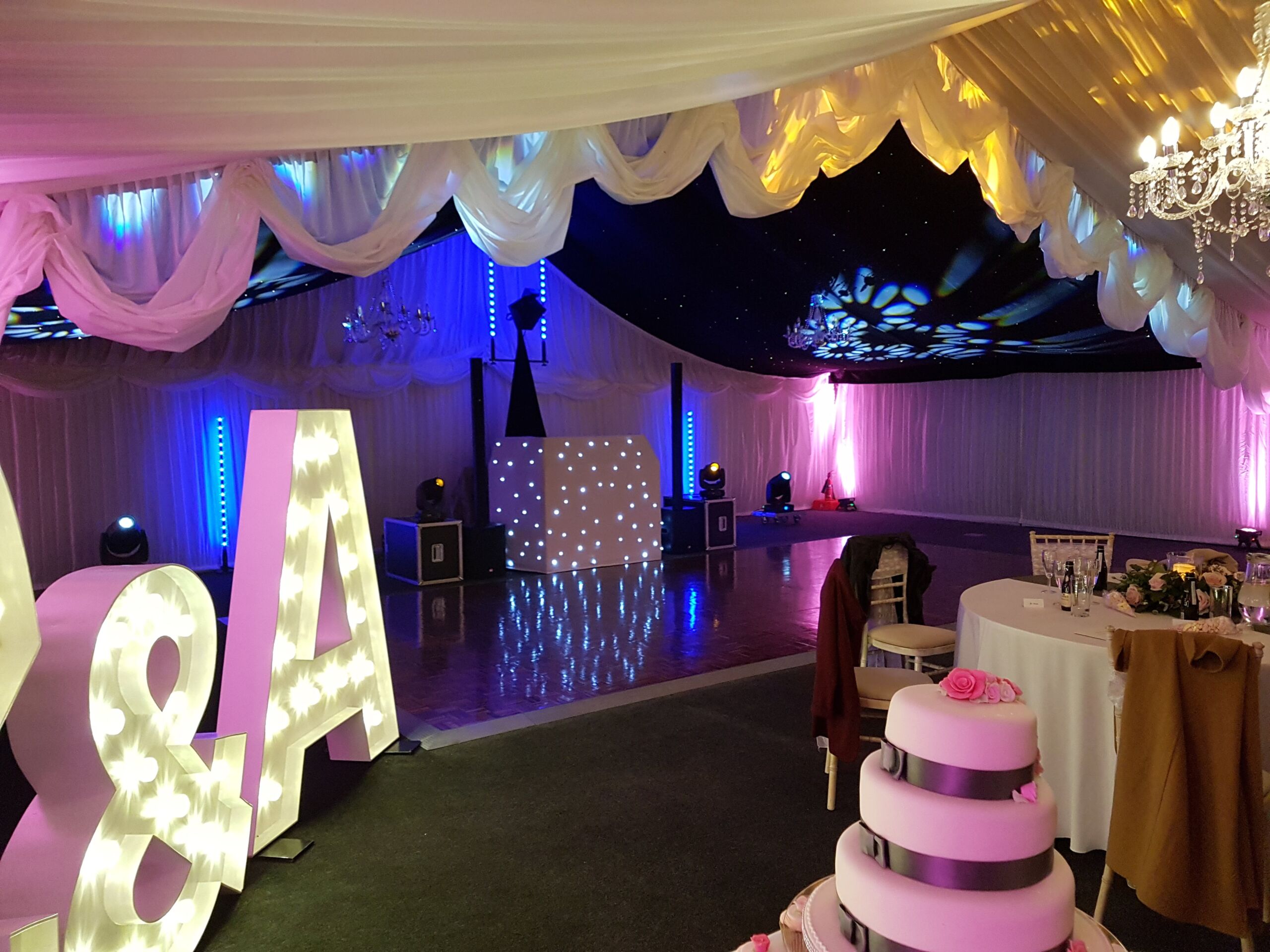 Mobile disco with white DJ booth, large lettters and cake