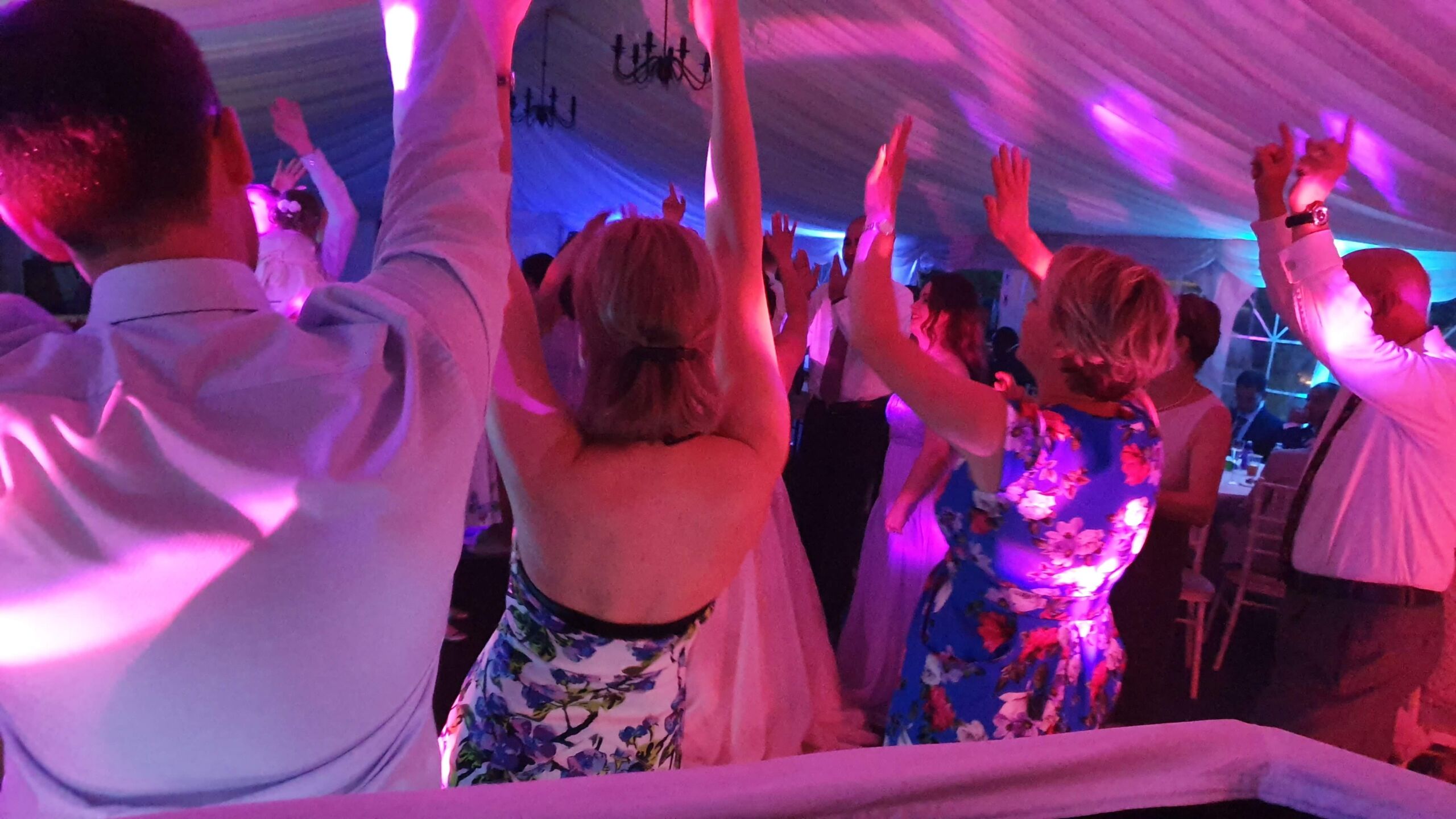 Dancers with hands in the air at a wedding