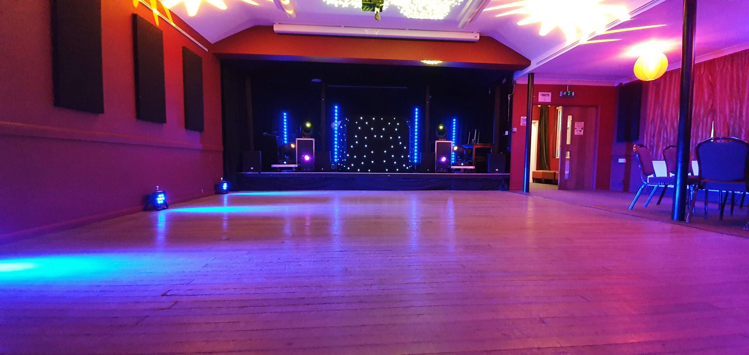 Mobile disco with starlit DJ booth and uplighting